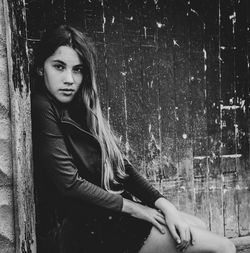 Portrait of young woman sitting outdoors