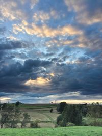 Scenic view of field against sky during sunset