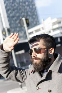 Portrait of young hipster businessman in the heart of city