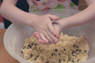 Midsection of girl preparing cookies at home