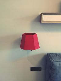 Close-up of electric lamp against wall at home