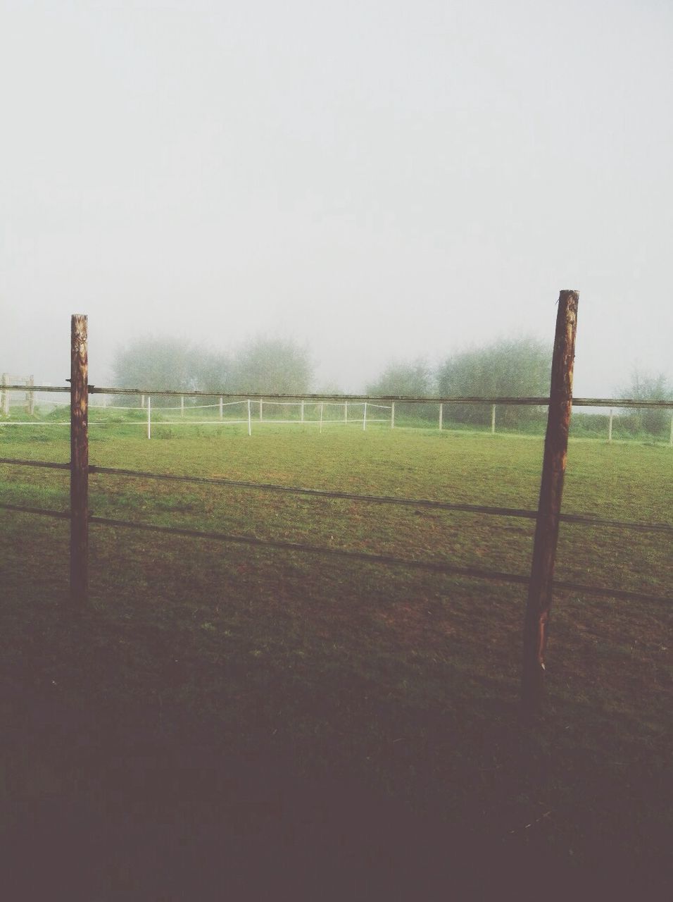 fence, grass, field, clear sky, protection, safety, copy space, landscape, security, grassy, day, sky, tranquility, weather, nature, metal, tranquil scene, outdoors, no people