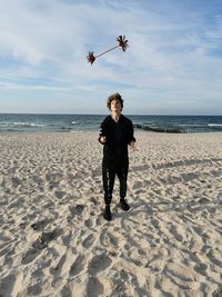 Full length of man on beach against sky