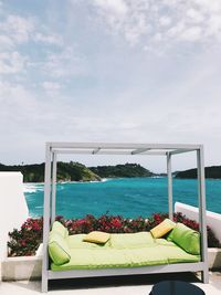 Scenic view of swimming pool by sea against sky