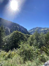 Scenic view of mountains against sky on sunny day