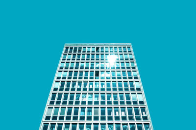 Low angle view of modern building against blue sky