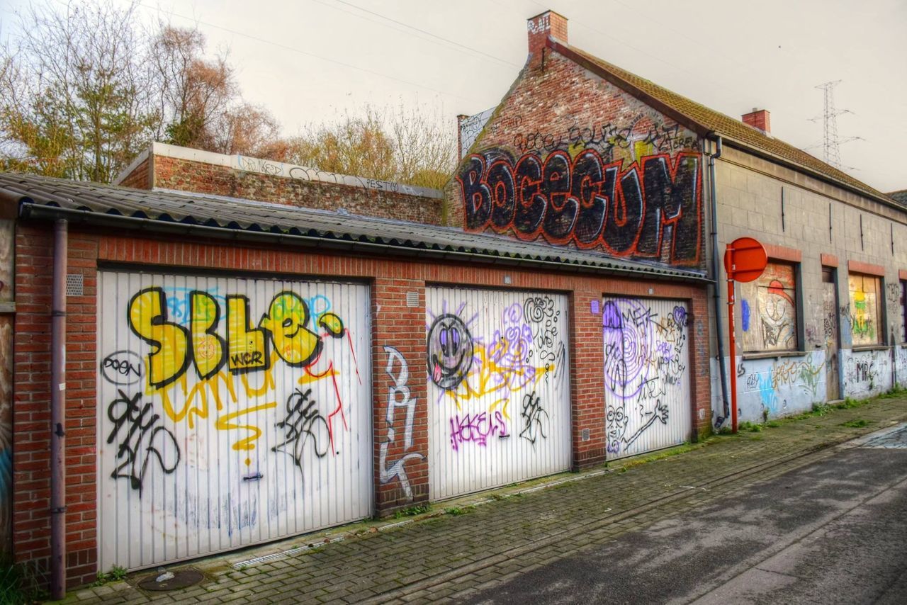 architecture, building exterior, graffiti, built structure, art, wall - building feature, art and craft, creativity, text, multi colored, street art, day, house, outdoors, wall, western script, no people, window, vandalism, communication