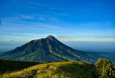 Scenic view of mountain against blue sky