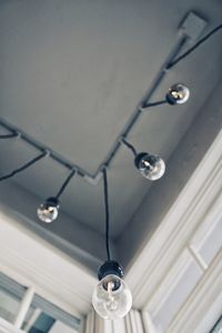 Low angle view of illuminated pendant light hanging from ceiling