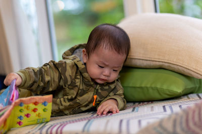 Portrait of cute baby boy sleeping on bed at home