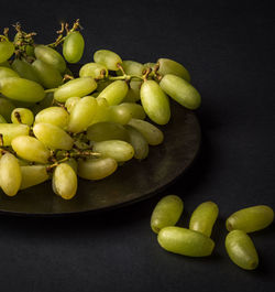 High angle view of grapes in bowl on table