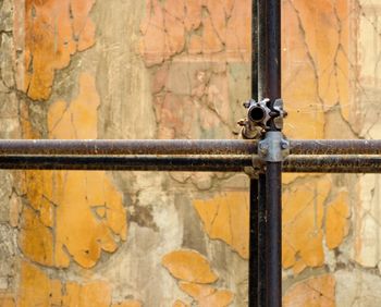 Close-up of rusty metal against wall