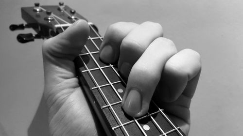 Close-up of hand playing guitar