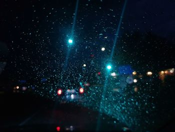 Raindrops on glass window at night