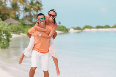 Full length of woman standing at beach