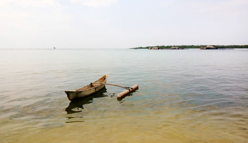 Person on sea against sky