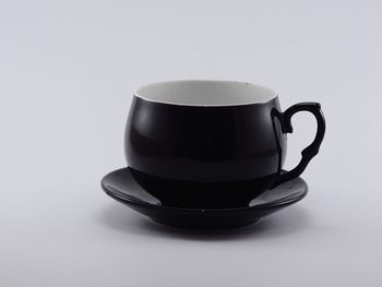 Close-up of coffee cup against white background