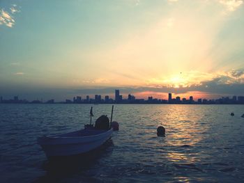 Boat in sea at sunset