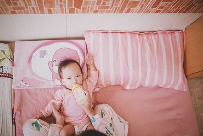 Cute baby lying on bed at home