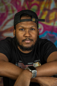 Portrait of young man standing at home
