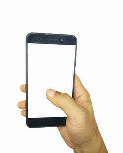 Close-up of hand holding smart phone against white background