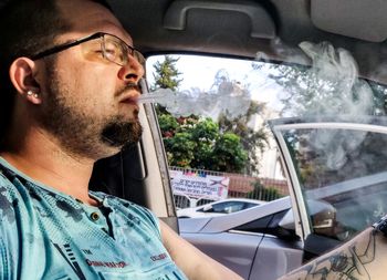 Portrait of young man in car