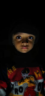 Portrait of cute boy in darkroom