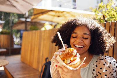 Portrait of young woman eating food