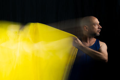 Time lapse view of man moving a rag. long exposure, motion blur. 