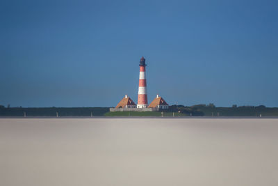 Lighthouse against clear blue sky