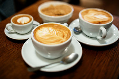 High angle view of fresh coffee served on table at cafe