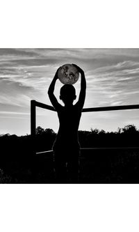 Silhouette woman standing by tree against sky