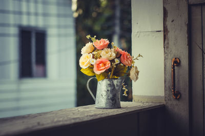 Close-up of flower vase against window
