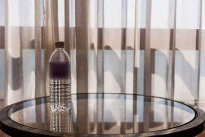 Close-up of glass bottle on table