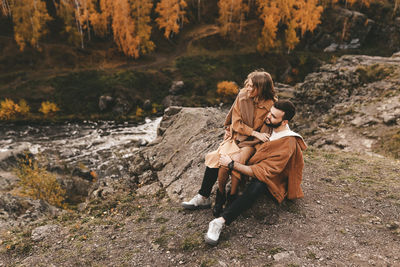 Young couple sitting on rock