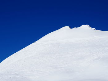 Distant view of person skiing in snow