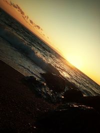 Scenic view of beach against sky during sunset