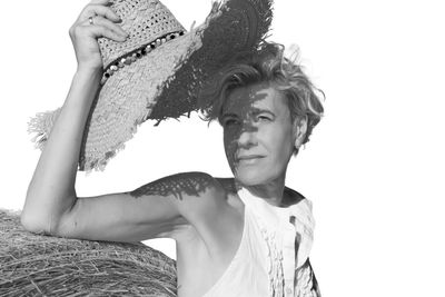 Portrait of beautiful young woman against sky