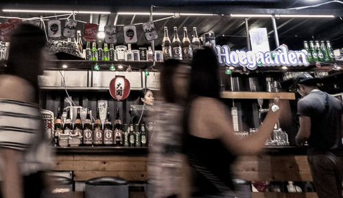 Blurred motion of people standing in kitchen