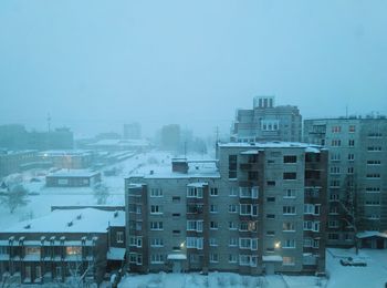 High angle view of buildings in city during winter