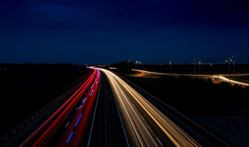 High angle view of light trails on highway at night