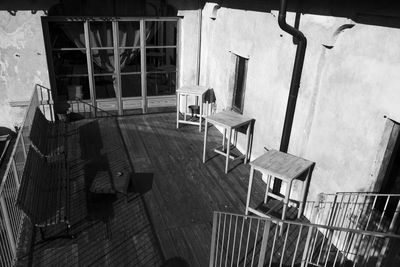 High angle view of empty chairs and tables against building