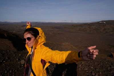 Portrait of man wearing sunglasses on mountain against sky