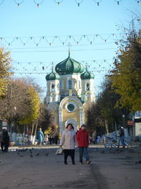 Group of people outside temple against building