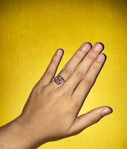 Close-up of woman hand with yellow tattoo