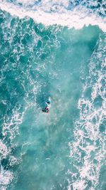 Directly above shot of people surfing in sea