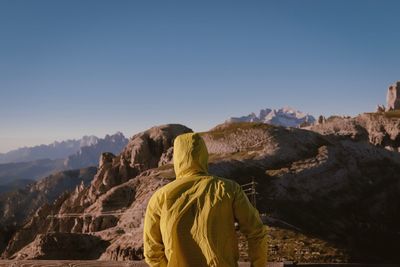 Rear view of person against mountains and sky