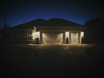 Illuminated building against sky at night