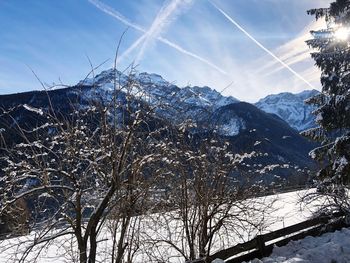 Low angle view of snowcapped mountains against sky