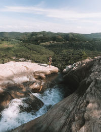 Scenic view of waterfall against sky